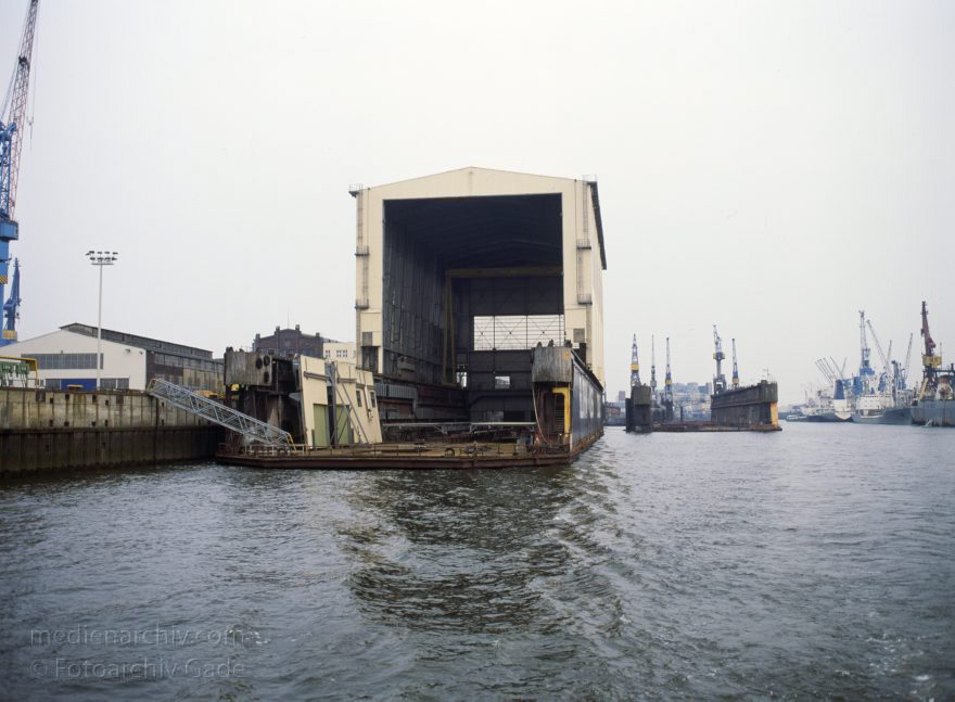 Deutschland. Freie und Hansestadt Hamburg. Hafen. Werft. Trockendock
April 1992. Deutschland. Freie und Hansestadt Hamburg. Hafen. Elbe. Schifffahrt. Schiffahrt. Seefahrt. Güterverkehr. Seetransport. Pier. Kaianlagen. Trockendock. Werft. 

Hamburg Harbour is a deep water harbour off the North Sea, on the river Elbe in Hamburg, Germany.
Schlüsselwörter: Deutschland;Elbe;Fluss;Frachter;Germany;Hafen;Hamburg;Kai;Schiffe;Seefahrt;Trockendock;1992;Werft