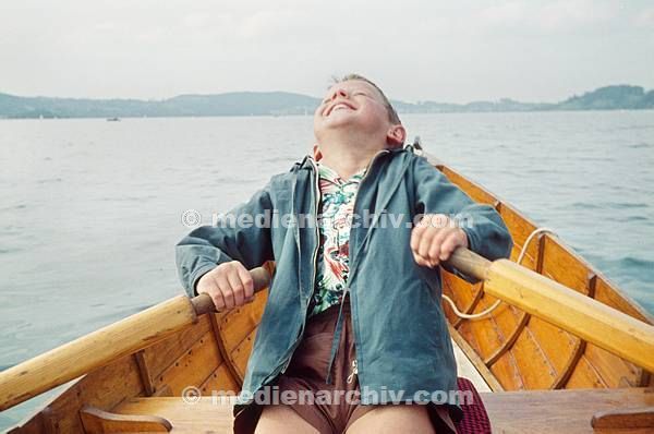 1960. Deutschland. Bayern. Tegernsee. Ein Junge rudert in einem Ruderboot. Germany Bavaria. Tegernsee is a lake in the Bavarian Alps. A boy in a boat.